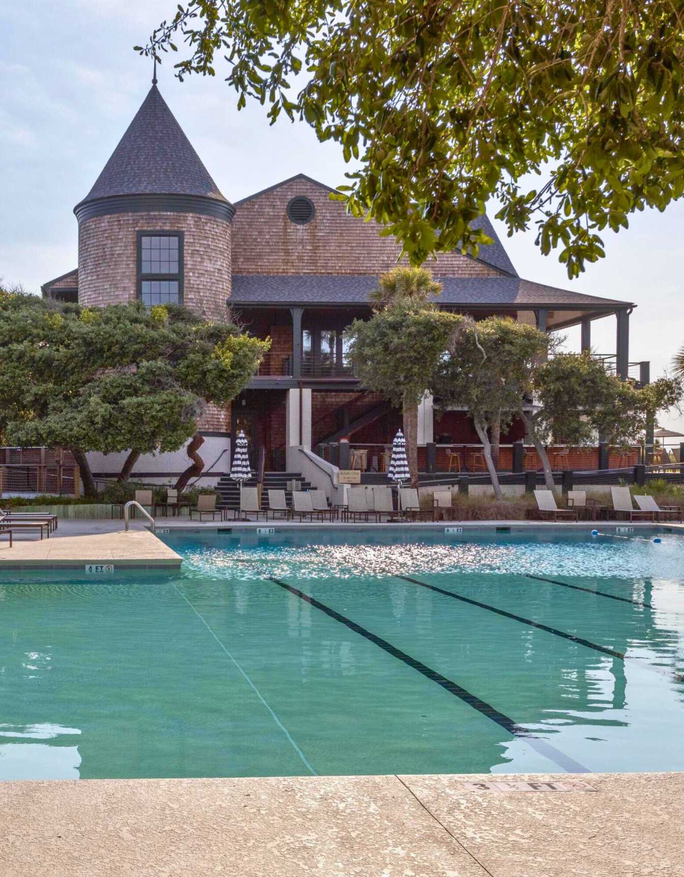 View of The Sandcastle, the private owners' amenity center on Kiawah Island, featuring its luxury swimming pool and iconic shingle-style architecture.