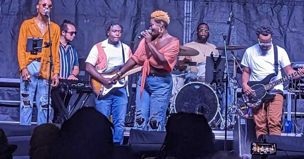 Live music performance on an outdoor stage during a local Charleston SC cultural festival.