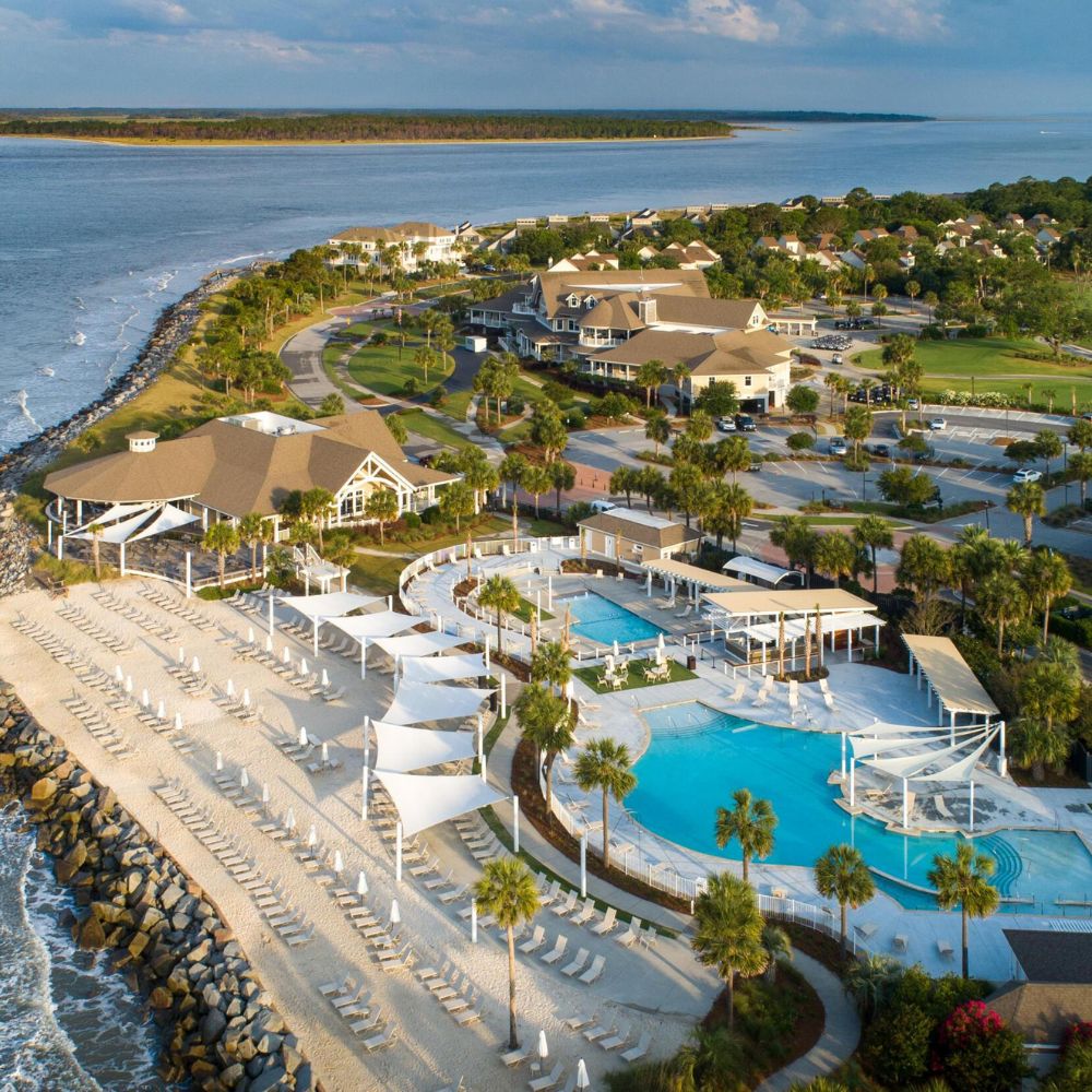 Aerial view of a luxury beachfront resort pool and private coastal community in Charleston, South Carolina.