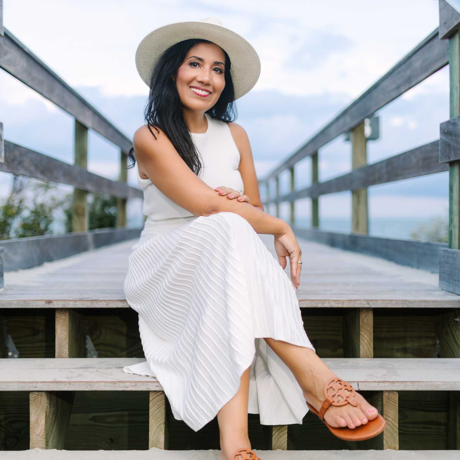 Michelle Almeyda-Wiedemuth, Folly Beach realtor with Live In Charleston, sitting on the iconic Folly Beach pier.
